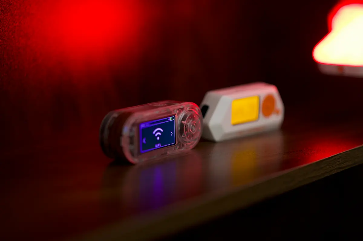Two electronic devices on a shelf